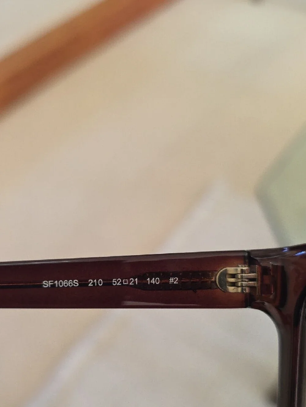 Salvatore Ferragamo SF1066S sunglasses feature a dark crystal brown frame